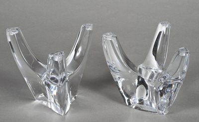 pair of clear glass vases sitting on top of a table