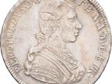 une pièce d'argent représentant le portrait d'un homme de profil
