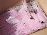 a box of pink plastic forks and spoons in it