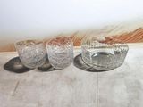 three glasses and a bowl on a table