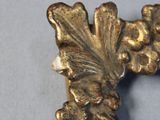 a gold cross on a table with a blue table cloth