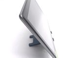 a tablet computer sitting on a stand on a white surface