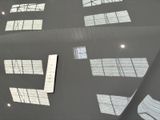many windows on the roof of a building with a skylight