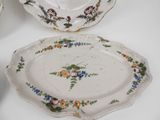 two plates with flowers on them sitting on a table