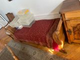 a bed that has a red blanket on it