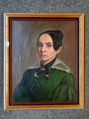 portrait of a woman in a green dress with a black bow tie