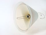 a white lamp that is on a white table