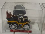 a small model of a car in a glass case