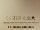 the back of a silver laptop with a barcode on it