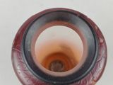 a picture of a vase that has a brown and black design on it