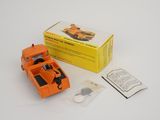 an orange toy truck that is sitting next to a box