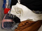 a pile of clothes sitting on top of a plastic bag