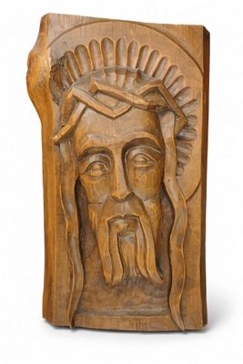 a close up of a carving of a man with a crown on his head