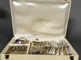 an open box with silverware in it sitting on a table