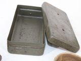 a small metal box with a wooden spoon next to it