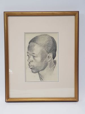 framed drawing of a young boy ' s head in a gold frame