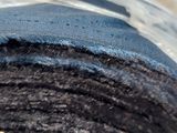 a close up of a piece of cloth in a bowl of water