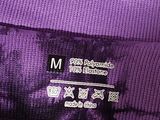 the purple bag is sitting on the table with the name of the bag