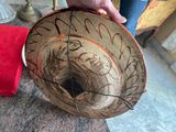 a person holding a bowl with writing on it