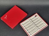 a red box that has a set of six pairs of scissors in it