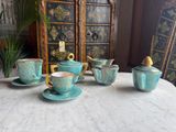 a lot of tea cups and saucers sitting on a table