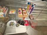 a glass display case filled with assorted food items