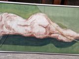 a painting of a nude woman laying on a green surface