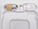 a white box with a charger and a cable attached to it