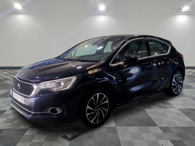 the blue car is parked on a checkered floor in a garage