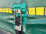 a close up of the side of a green train