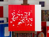 a picture of a painting on a easel in front of a bunch of pictures