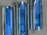 three blue lighters sitting on a wall next to each other