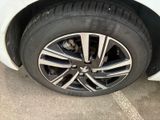 a close up of a tire on a white car