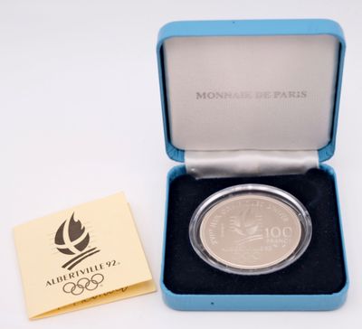 an image of a silver coin in a blue box with a yellow card