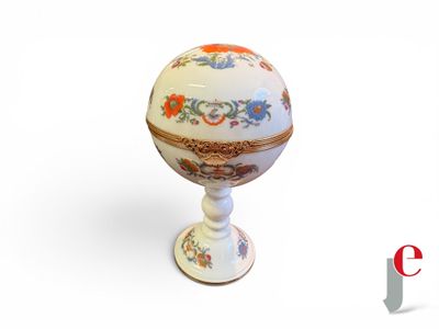 a small white egg with a floral design on it