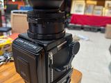 a black camera sitting on top of a wooden table