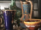 many different vases on a shelf next to each other