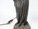 an image of a statue of a woman with a bird on her shoulder