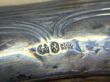 a close up of a silver plate with a logo on it