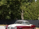 a red and white car that is parked in a parking lot