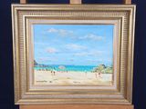 a picture of a painting of a beach scene on a easel
