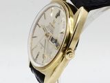 an image of a wrist watch with a gold case and black leather strap