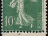 a green and white stamp with a picture of a woman on it