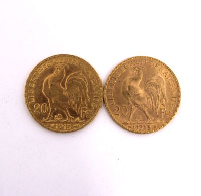 two gold coins, one of which is a rooster and the other of which is a rooster