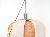a white and orange lamp that is on top of a table