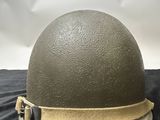 the helmet is made of plastic and has a metal buckle on the side