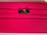 a pink leather wallet with a metal clasp