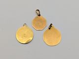 three gold plated charms on a white background