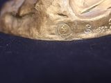 a gold statue of a horse on a black surface