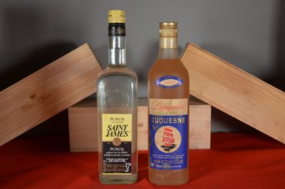 two bottles of liquor sitting next to each other on a table